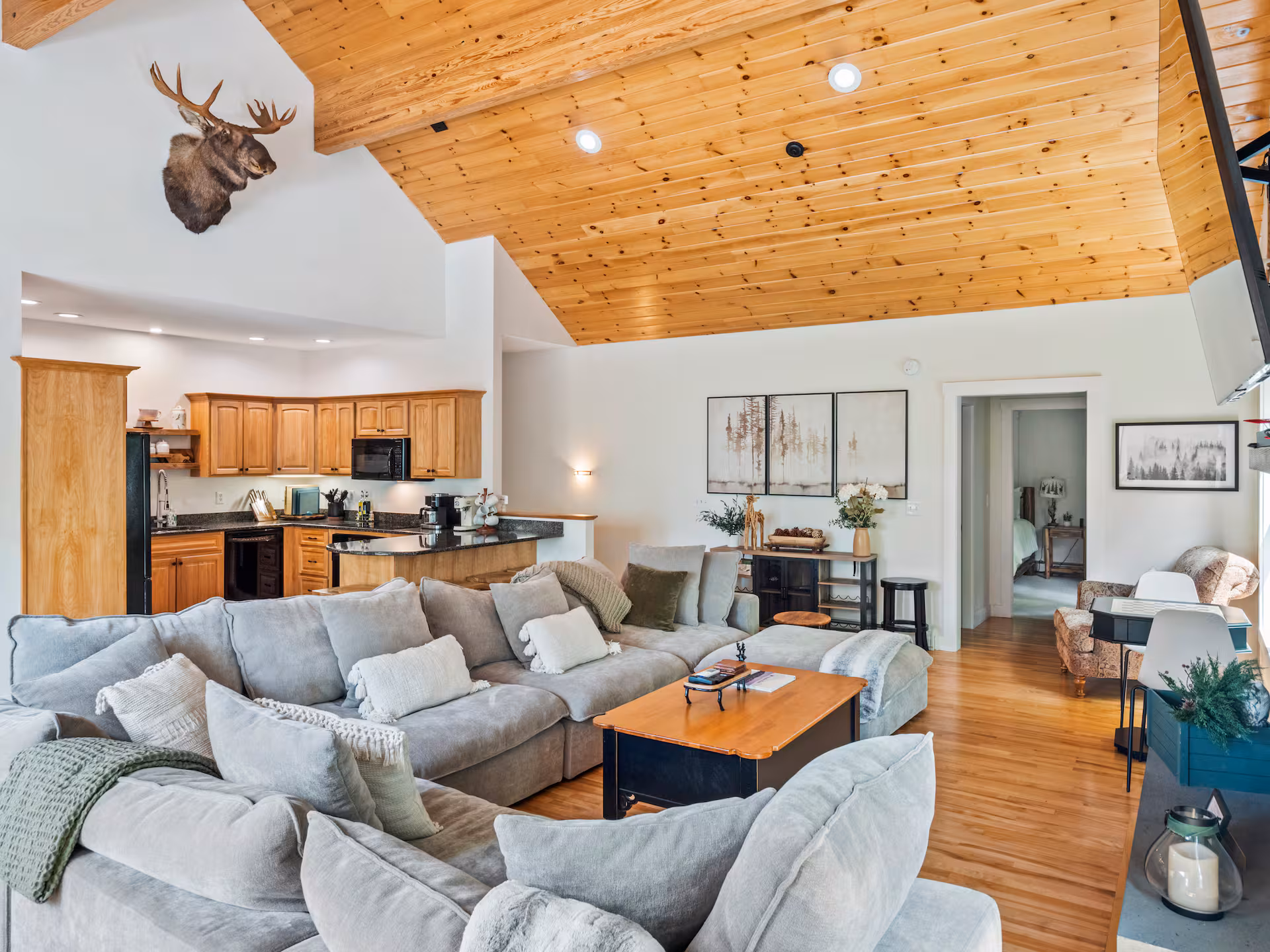 Open living room with oversized couches and connected kitchen area.